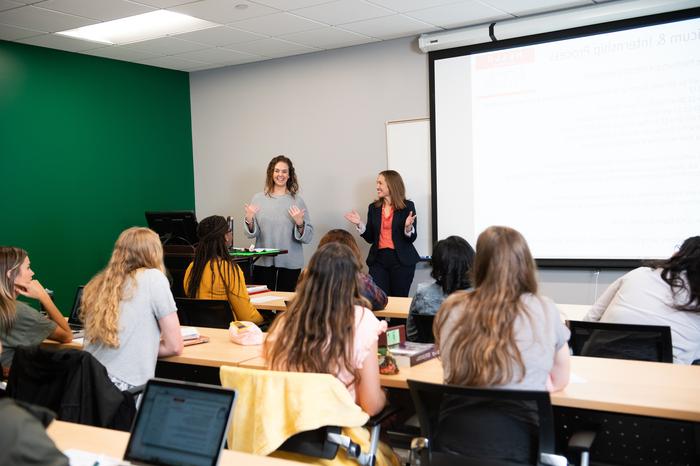 Two female teachers instructing a class